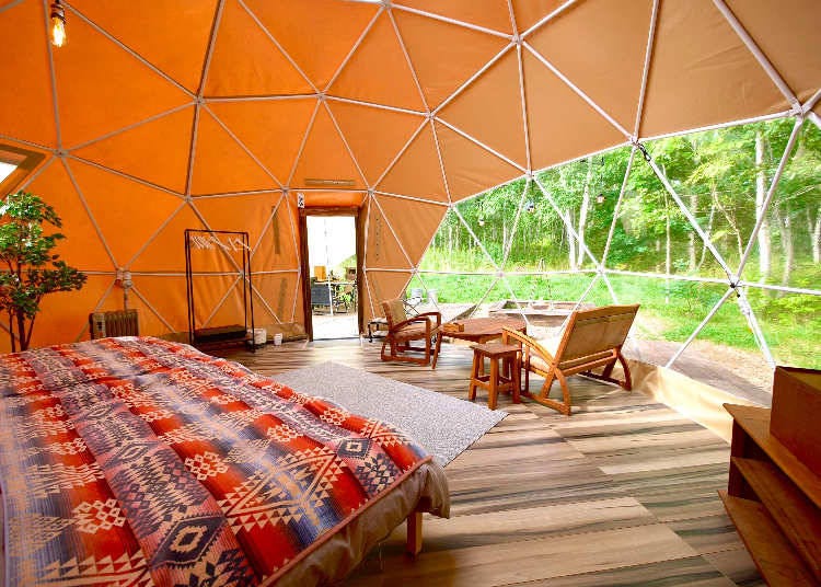 One of the glamping domes has a stylish atmosphere complete with antique furniture (Photo courtesy of Takibi Camp)