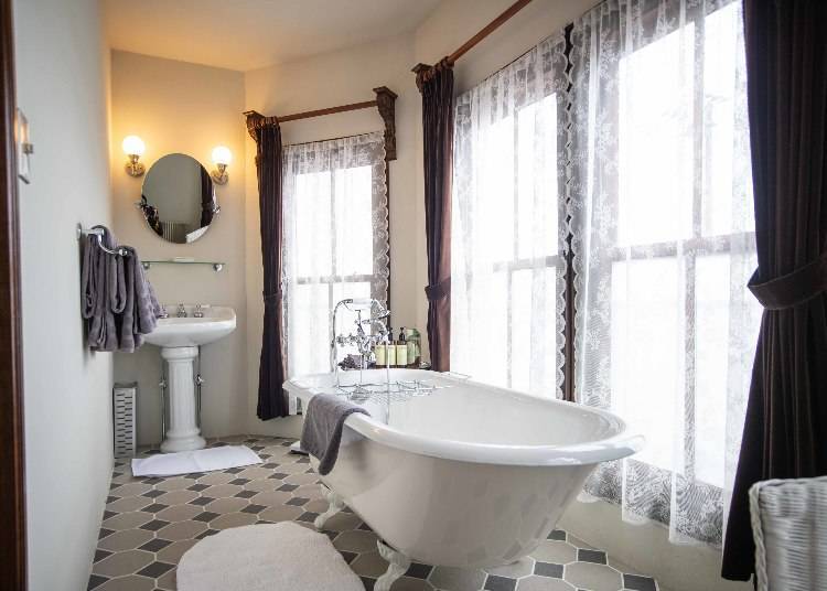 A stylish bathroom with a cabriole-legged bathtub