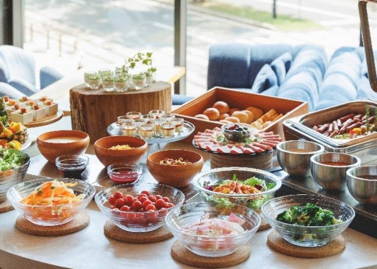 Colorful half buffet featuring salads, soups, breads, and desserts