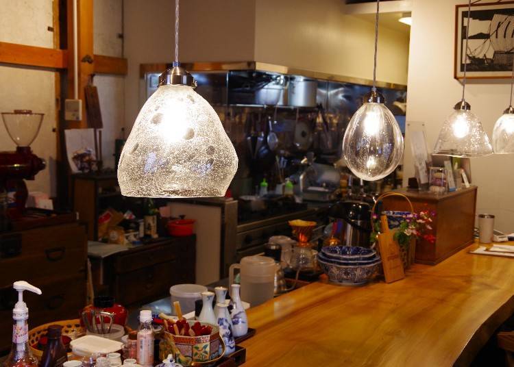 The cafe’s ambiance is enhanced by gorgeous glass lamp shades of different shapes.