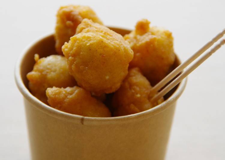 The fried squid wings are served in a cup.