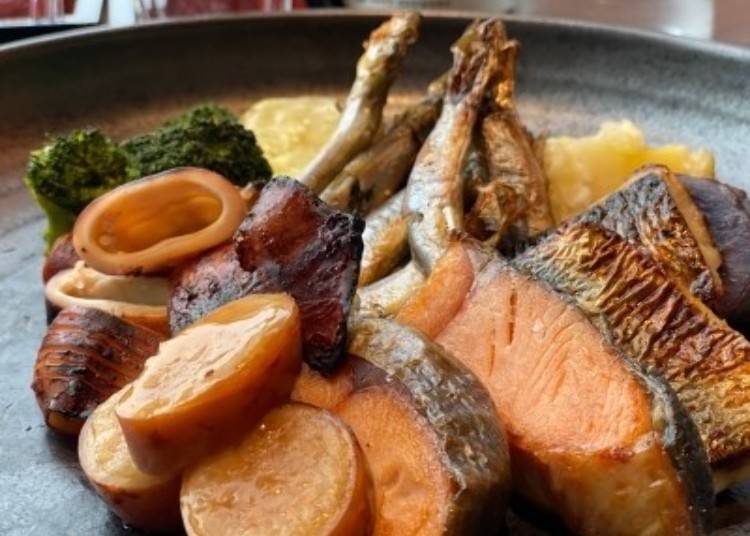 Ikameshi (front) and grilled seafood and salmon.
