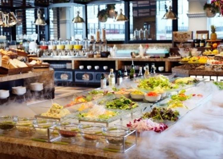 A salad bar with a variety of fresh vegetables, changing daily, just like a market.