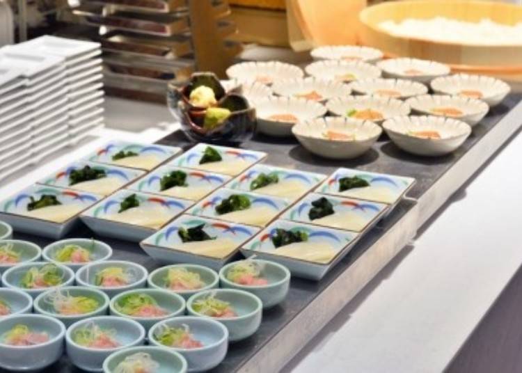 The squid sashimi (center) is served in small portions on individual plates, making it easy to take.