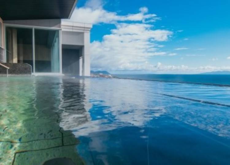 Enjoy the hot springs at the 'Infinity Open-Air Bath,' where it feels like the ocean blends seamlessly with the horizon.