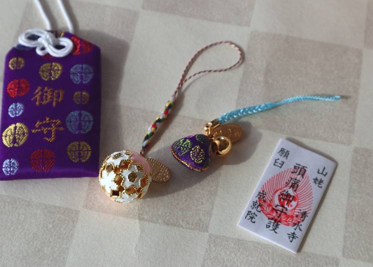 From left: o-mamori general protection charm 500 yen, good luck sakura bell 500 yen, good fortune charm 400 yen, headache protection charm 100 yen