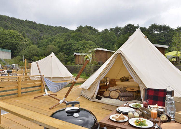 Relax in luxurious tents with comfy beds and sofas