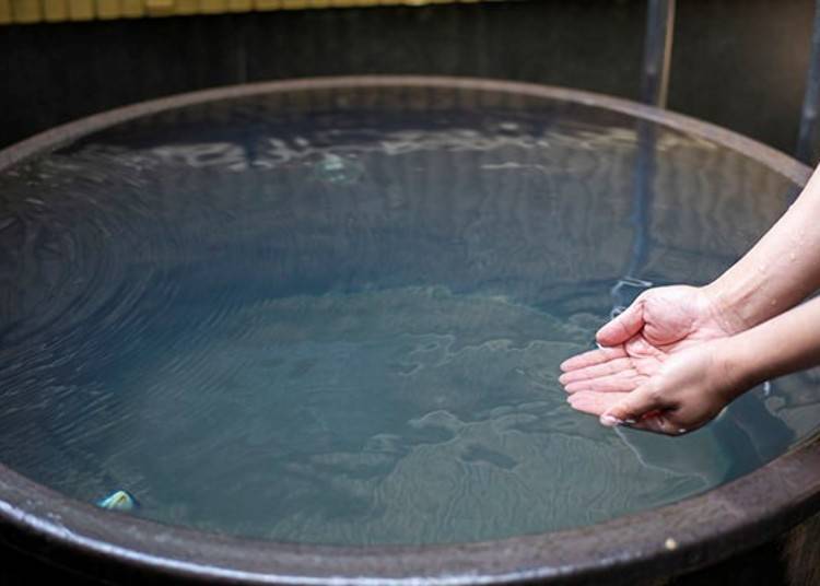 Hot spring water straight from the source at Hinoki's tub bath. A warming 26 degrees Celsius.