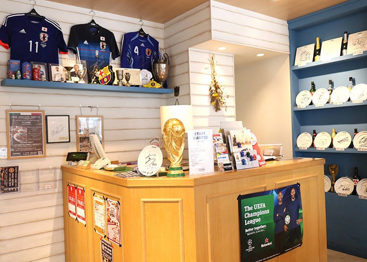 Soccer uniform replicas and athletes' autographs decorate the store