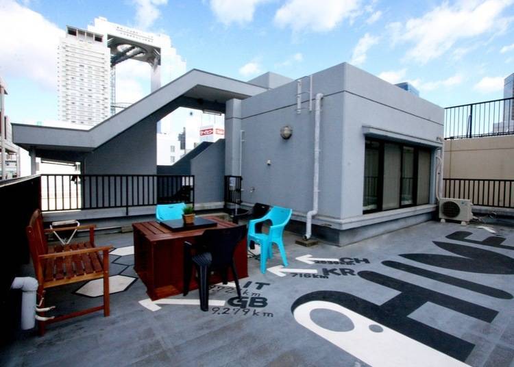 Relax on a rooftop space overlooking the Sky Building!