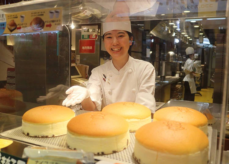 Freshly baked cheesecakes lined up at the storefront