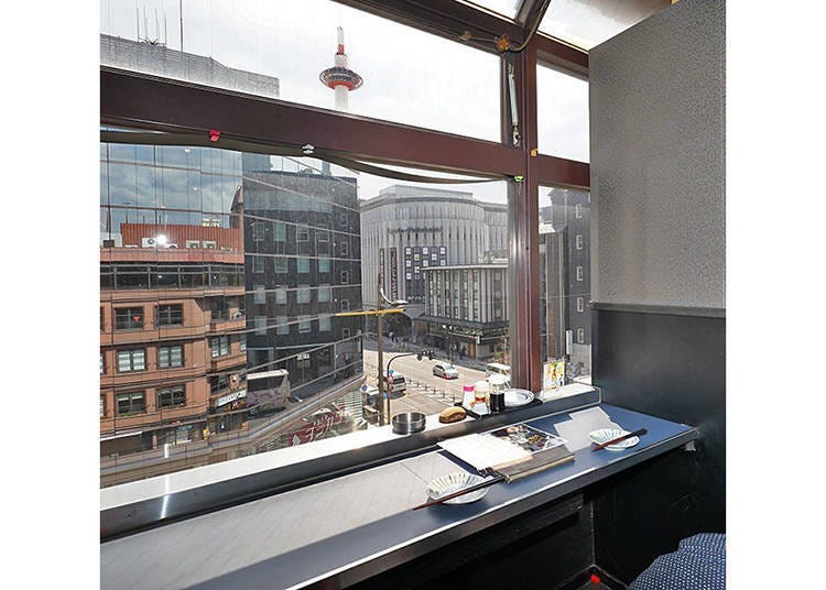 A relaxing couple seat with a view of Kyoto Tower from the large window
