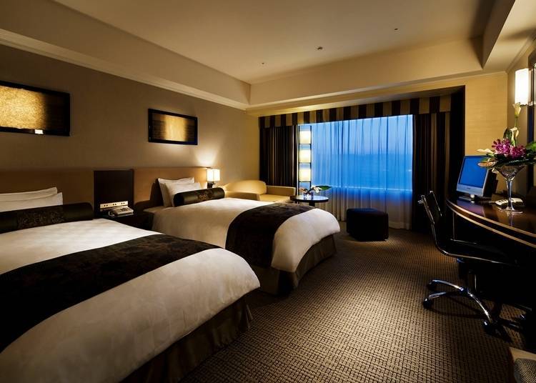 The superior twin rooms have large windows that either overlook the Higashiyama District or the streets of Kyoto below