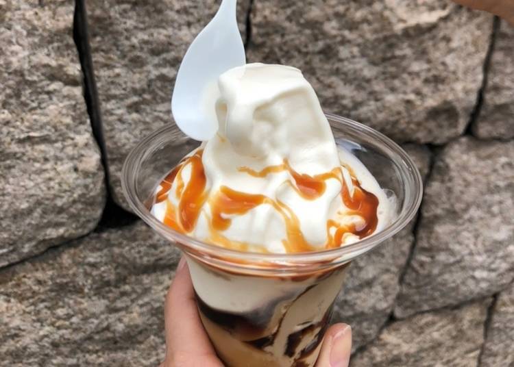 The caramel macchiato pudding parfait is topped with a generous drizzle of caramel sauce.