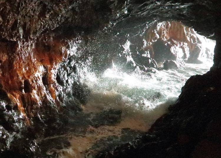 Waves break inside the cave at high tide