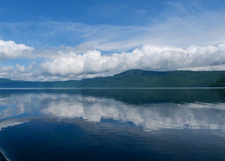 Lake Towada's summer scenery features beautiful mountains and the vast, blue sky, reflected on the lake
