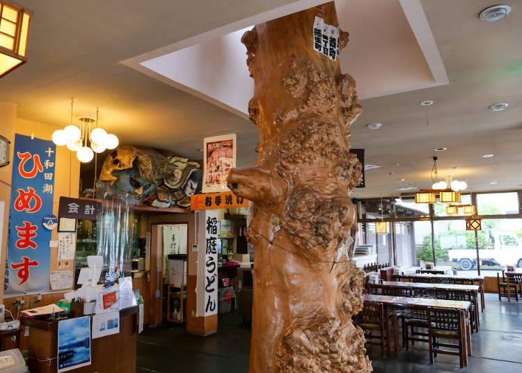 A large chestnut tree grows through the center of the shop, and tables made of chestnut wood line the eating space