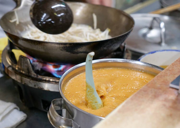 In the kitchen, homemade miso and milk, and curry powder, are lined up