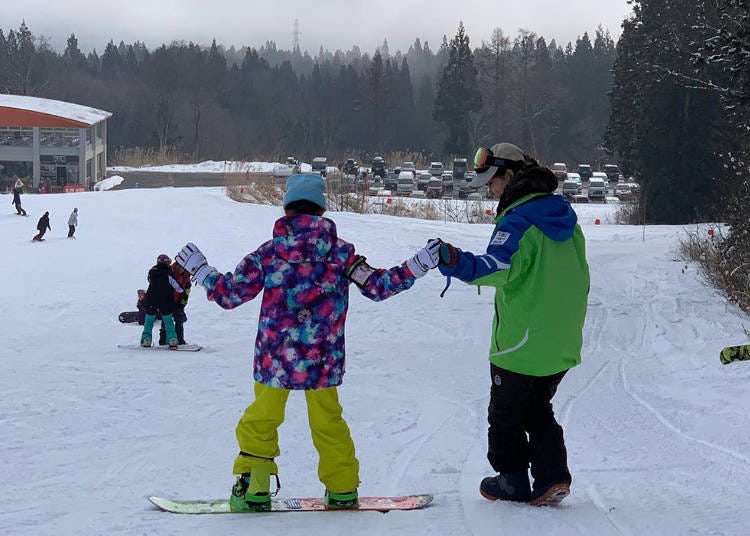 子どもにスノーボードを教えるインストラクター（写真提供：杉ノ原スキー場）
