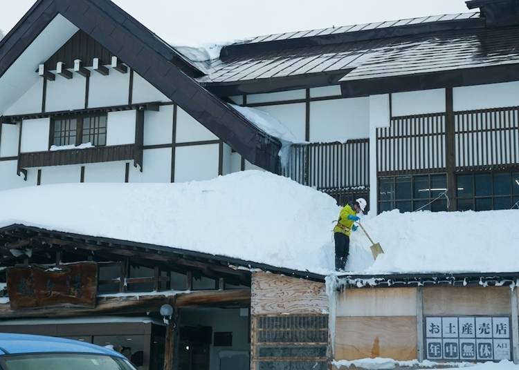 You can see people shoveling snow off roofs with safety harnesses on