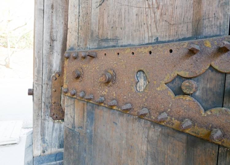 Interesting, heart-shaped metal fittings decorate the door.