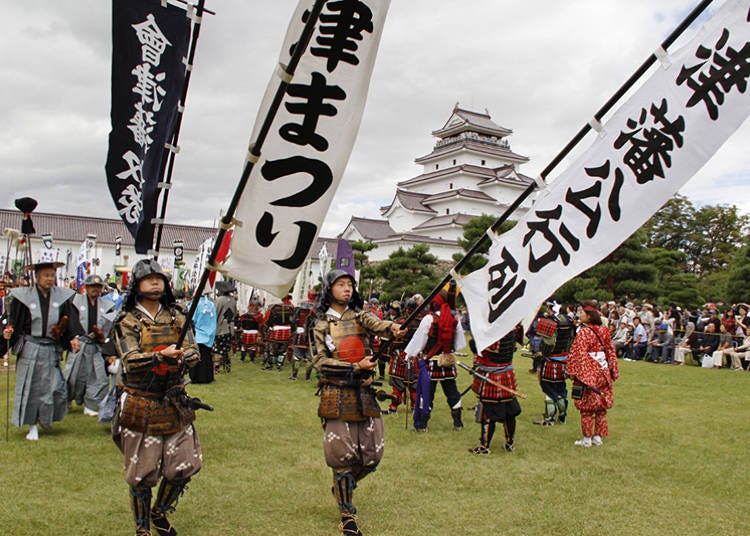 Citizens of Aizu-Wakamatsu keep the samurai spirit alive during a battle reenactment in front of Tsurugajo Castle. (Photo courtesy of Fukushima Travel.)
