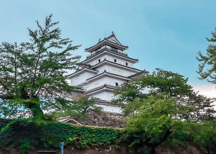 Once controlled by powerful samurai, Tsurugajo Castle looms over the castle park below. (Photo courtesy of Expedition Japan.)