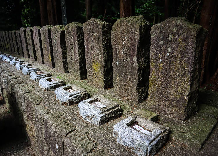 A line of headstones marks the graves of a group of young samurai who took their own lives on Mt. Iimoriyama during the Boshin War. (Photo courtesy of Expedition Japan.)