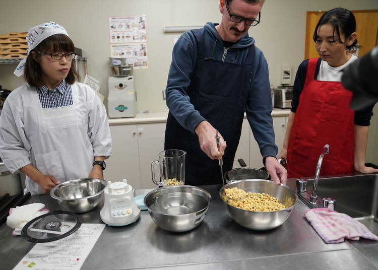 Ladling soybeans into a blender