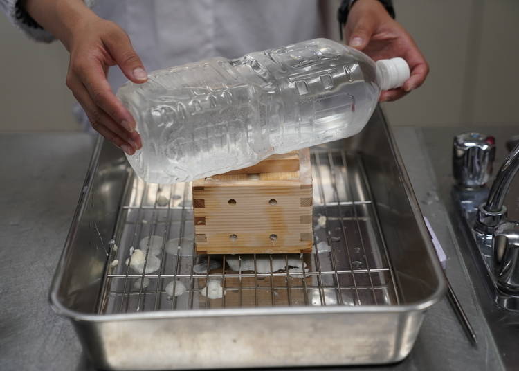 A heavy weight helps squeeze every last drop of liquid from the tofu