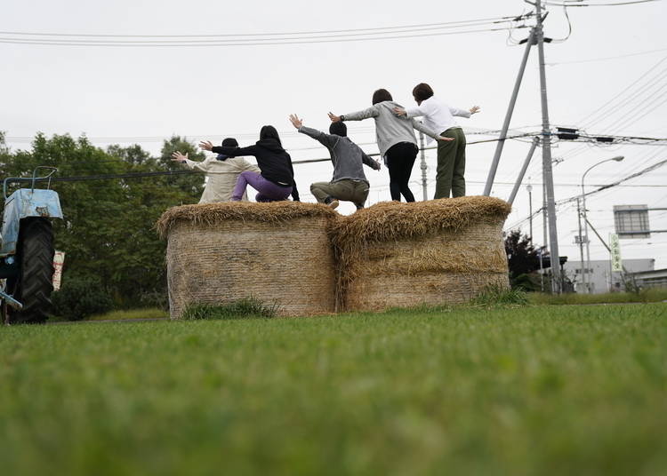 Visitors pose for pictures outside Tokachi Agriculture Museum Obihiro Visitor Center