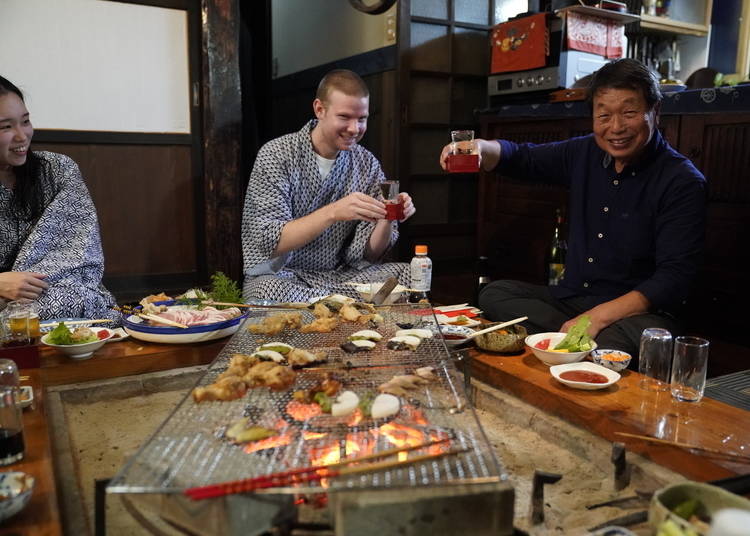 A feast of vegetables, pork, chicken, and fish, accompanied by ample servings of sake