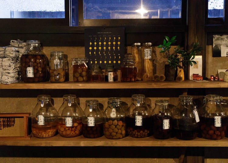 Jars of pickles and homemade liquors line the shelves