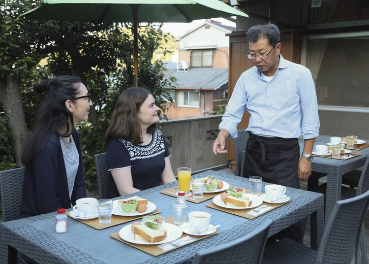 Guesthouse & Cafe Anzu owner Teruaki Kubo serves breakfast
