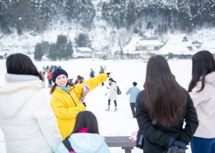 A guide explains a point of interest in Miyama