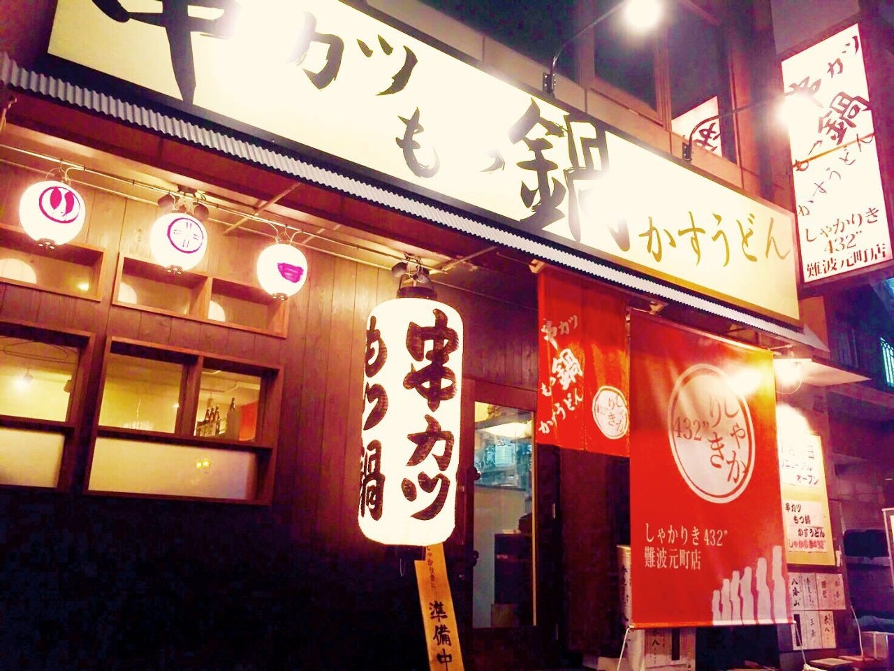 白の提灯に赤の暖簾が目を惹く「しゃかりき432” 難波元町店」外観