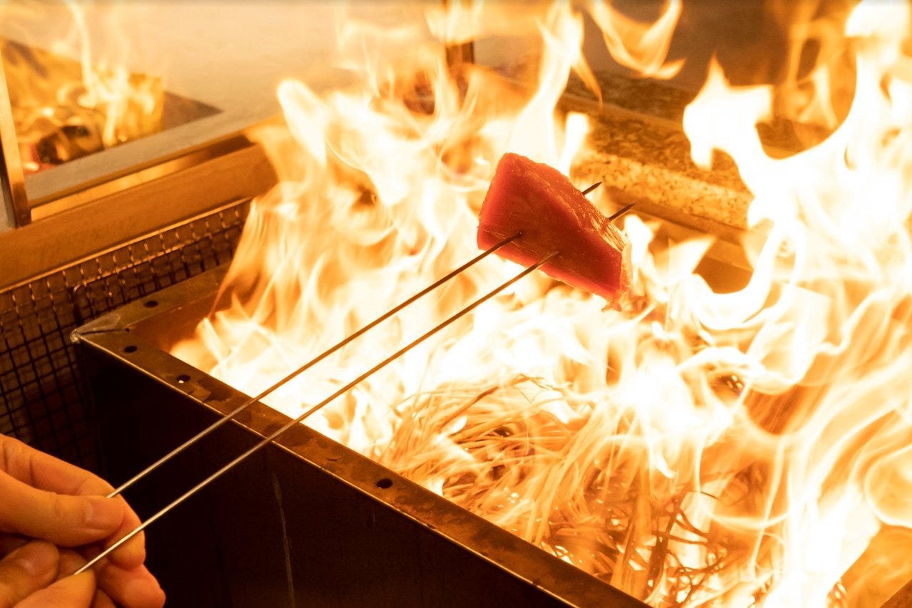 専用の焼き場の豪快な炎で調理する藁焼き