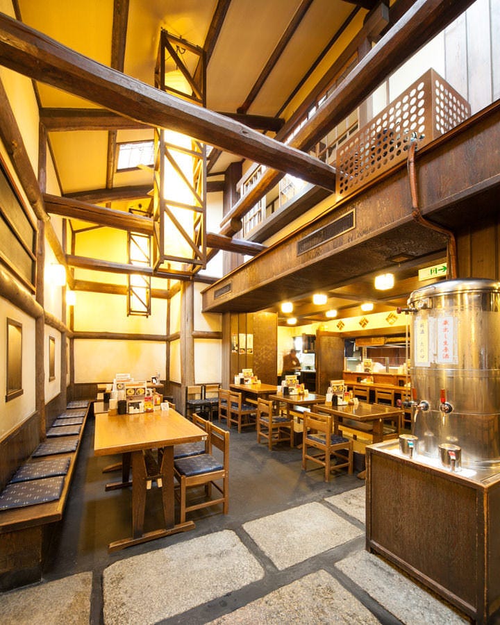 高い天井が特徴的な木造の店内と並んだ椅子・テーブル
