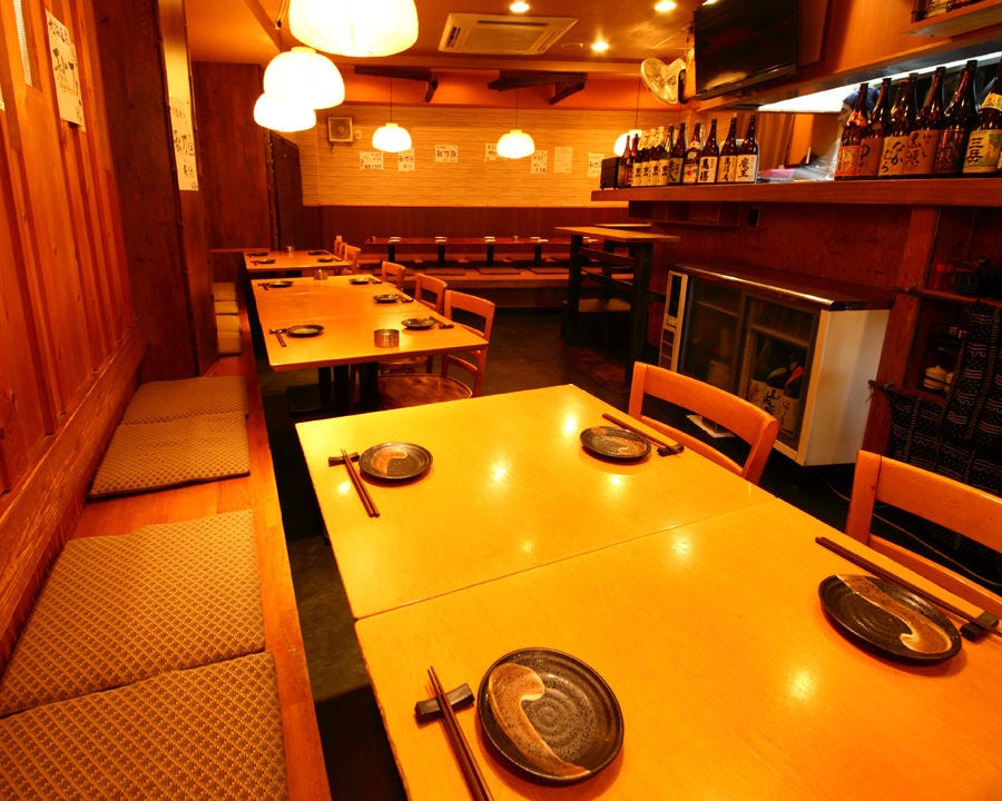 木の温かみを感じるテーブル席が並んだ気まぐれ厨房 ごっつ 青物横丁店の店内