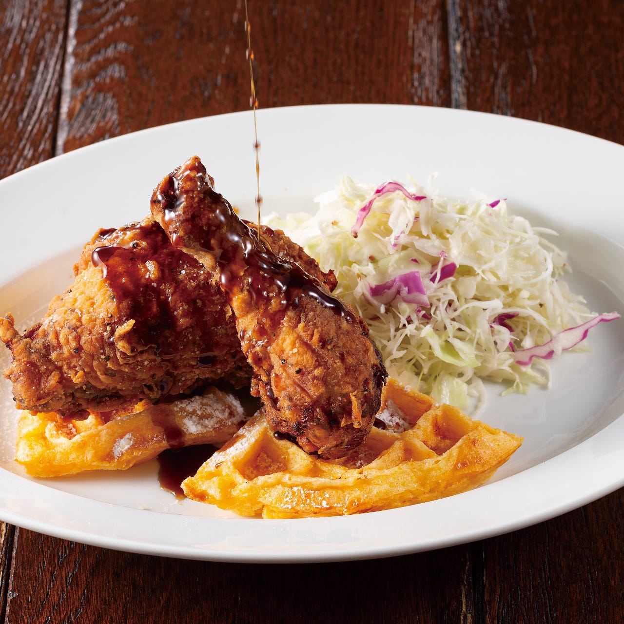 ワッフルにバターミルクフライドチキン、コールスローが添えられたランチ