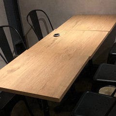ROUGH cafe dinning bar_無機質な空間に浮かび上がるように映える、木目の優しいテーブル席