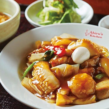 カレーライス・スープ・漬物・サラダ・杏仁豆腐がテーブルに並んでいる