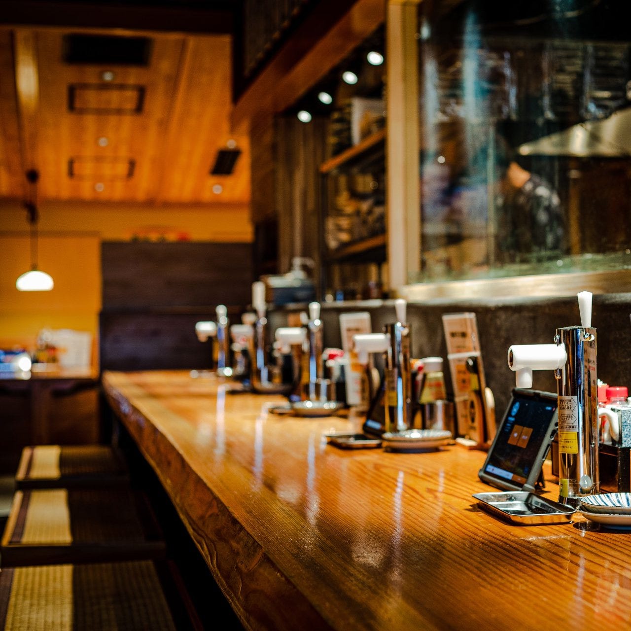 全席の卓上に、レモンサワーのサーバーが並ぶ乾杯500酒場 新橋店の店内カウンター席